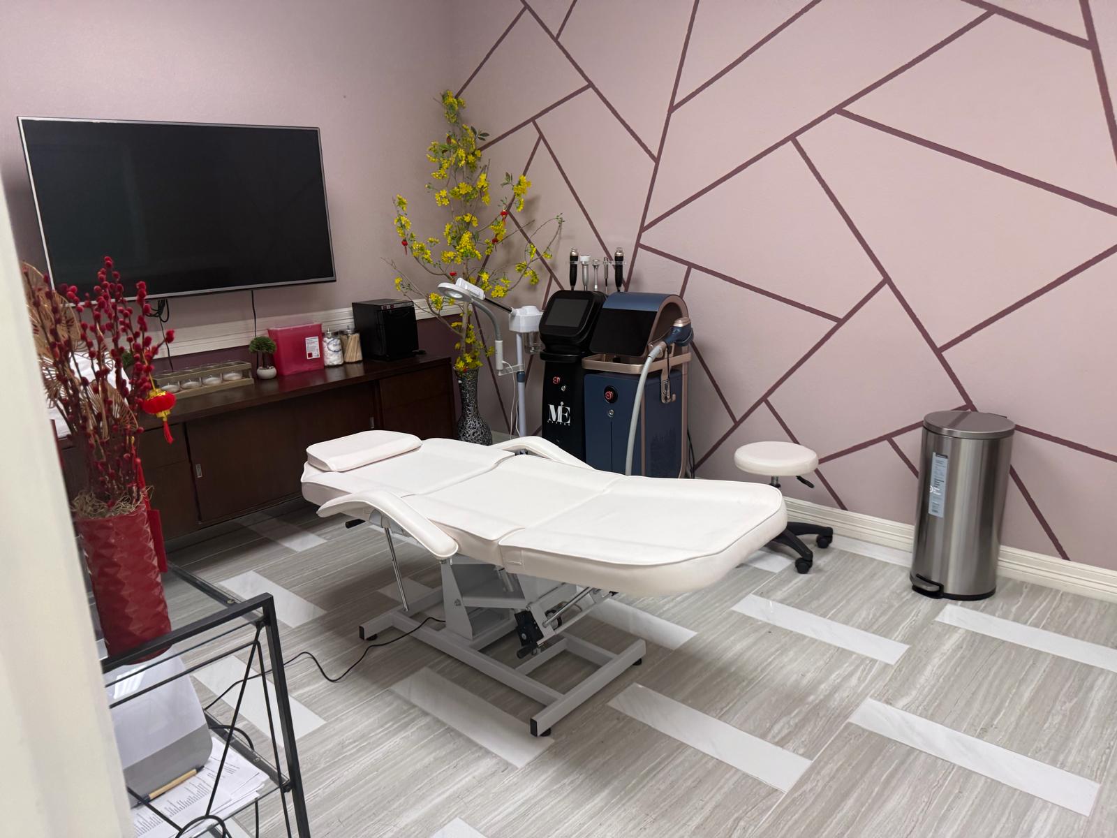 Treatment room at Rest and Beauty Spa with a reclining bed against the rose geometric wall